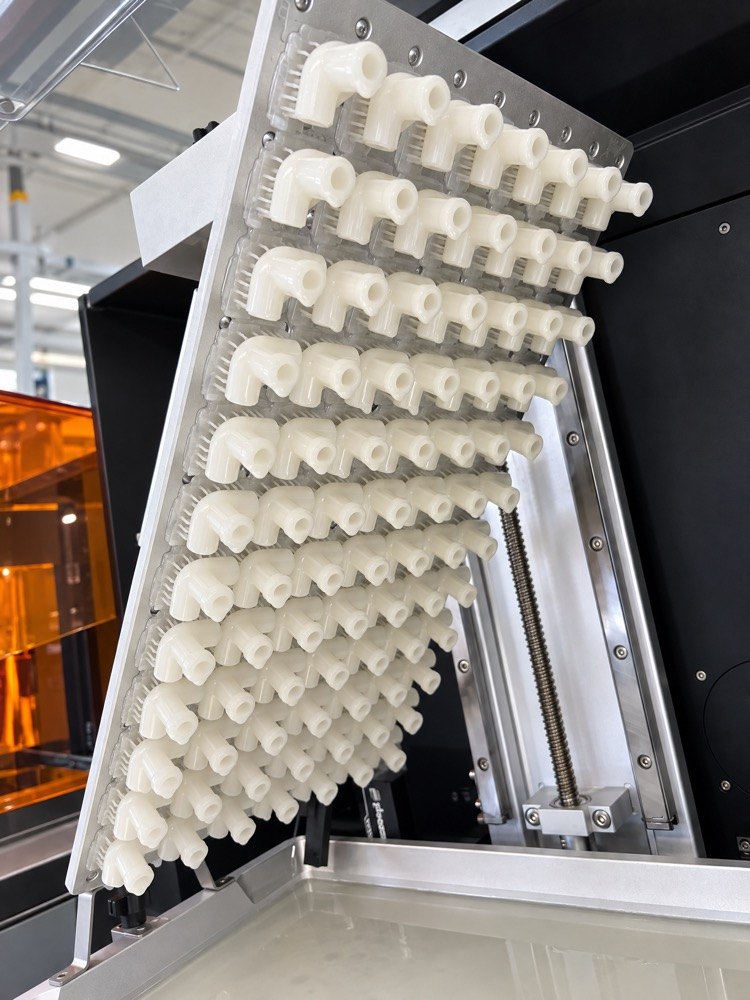An SLA build plate of production parts