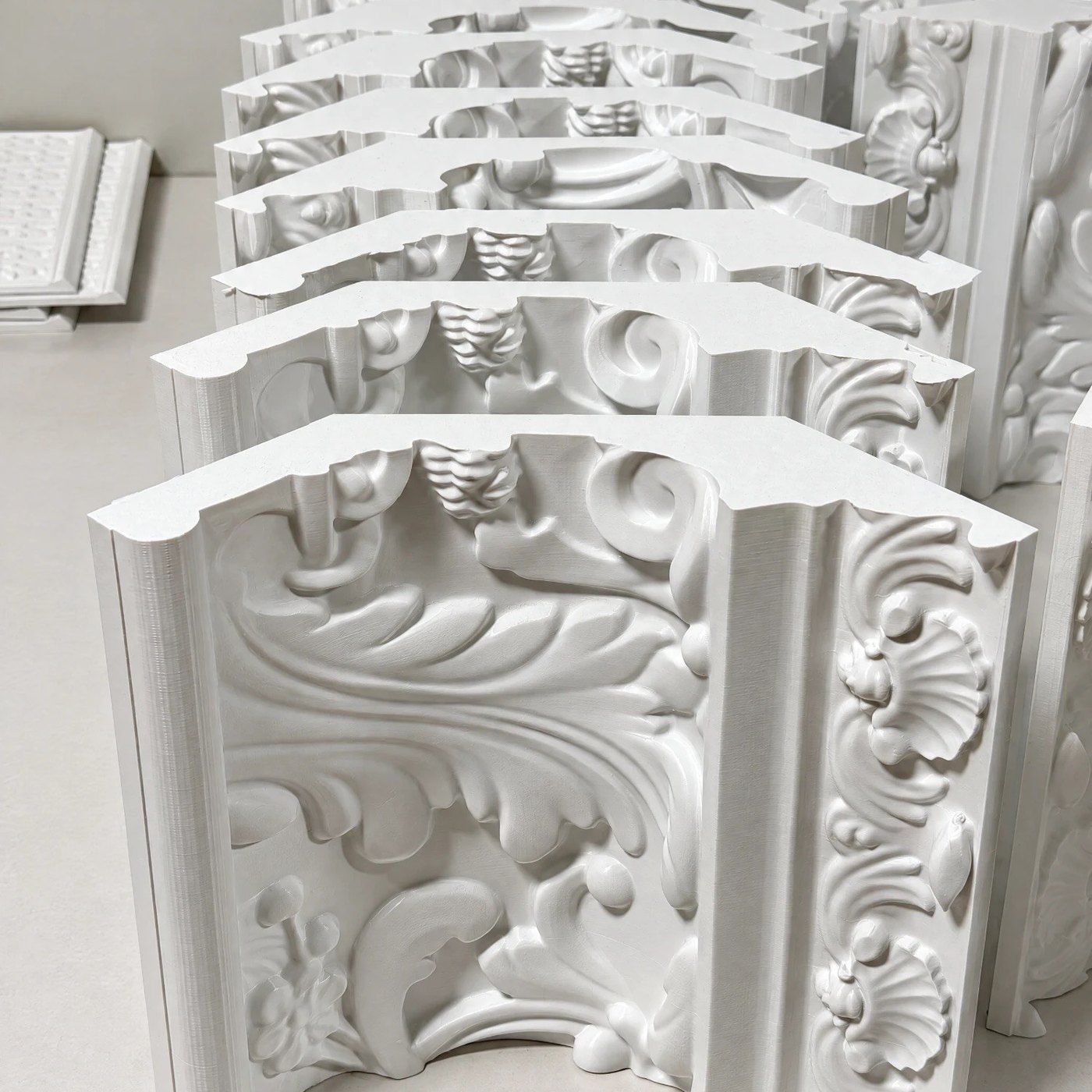 A row of finished ornate molding sections