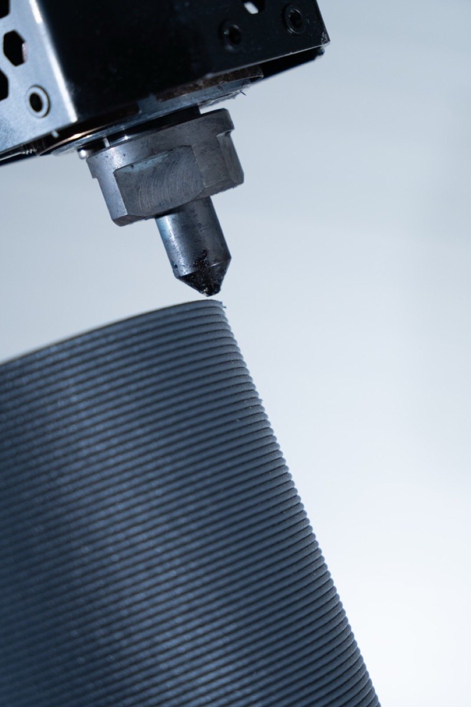 Close-up of an LFAM nozzle laying a bead