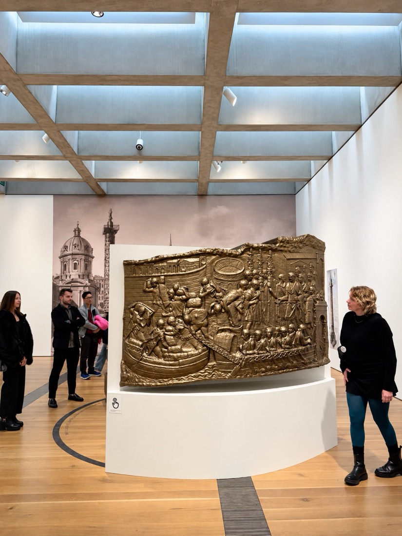 A bronze-finish relief installed in a gallery
