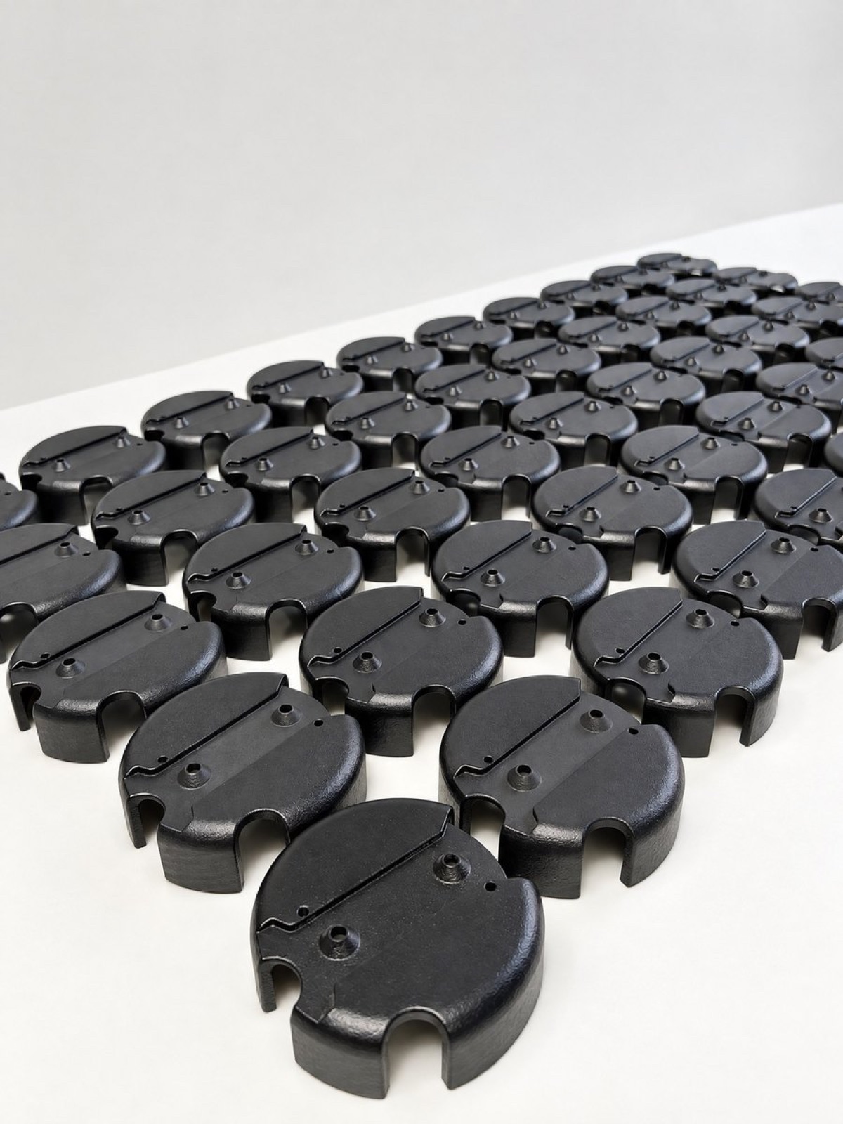 Batch of UV-stable black nylon caps arranged in production rows