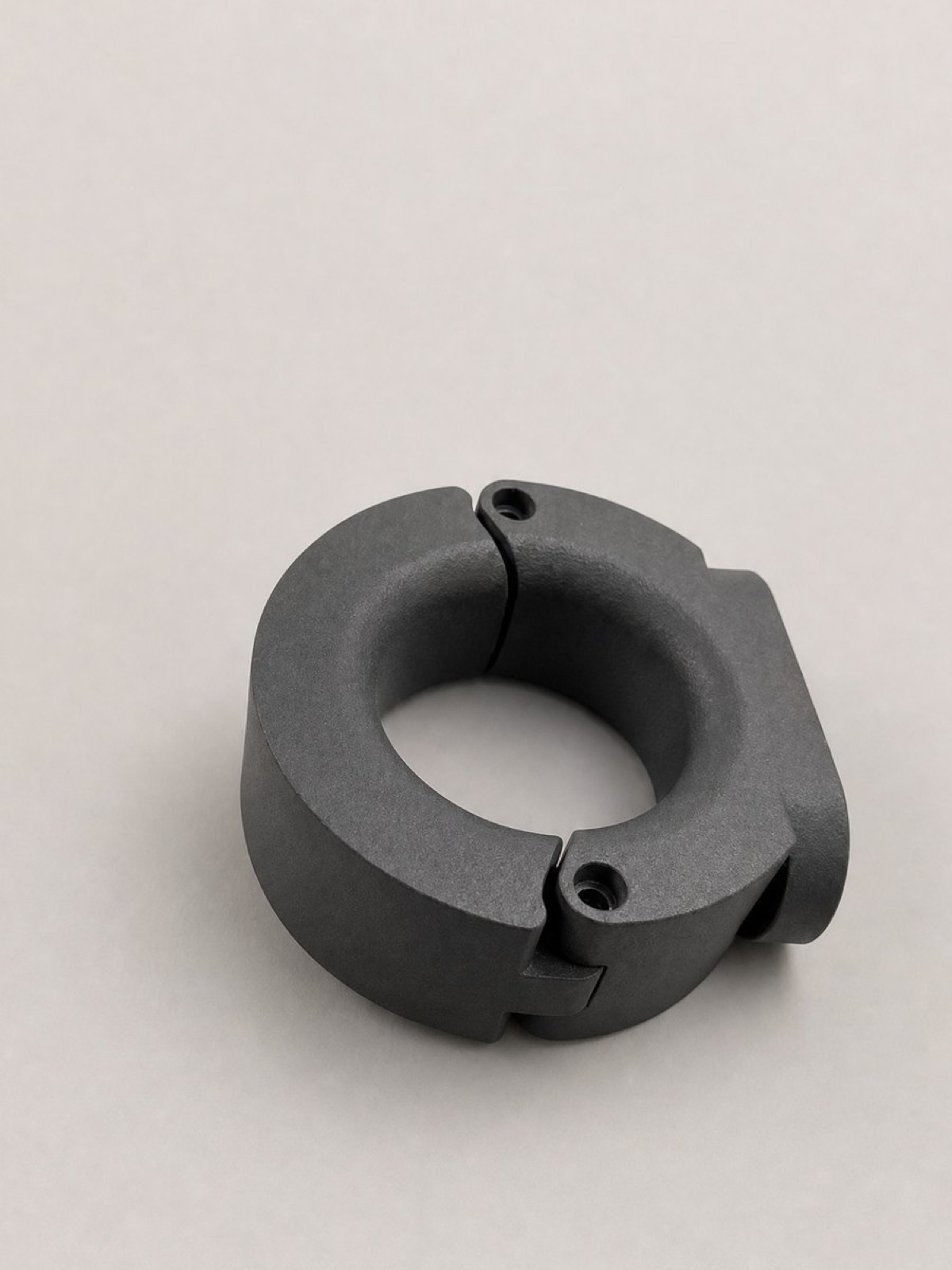 Grey nylon circular clamp with mounting holes for a robotic cell