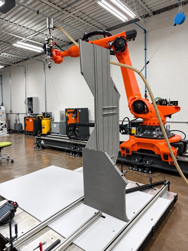 A robot cell printing a tall automotive part