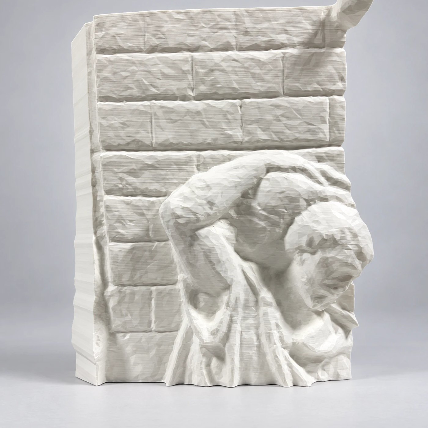 A single printed relief section, a figure against a brick wall