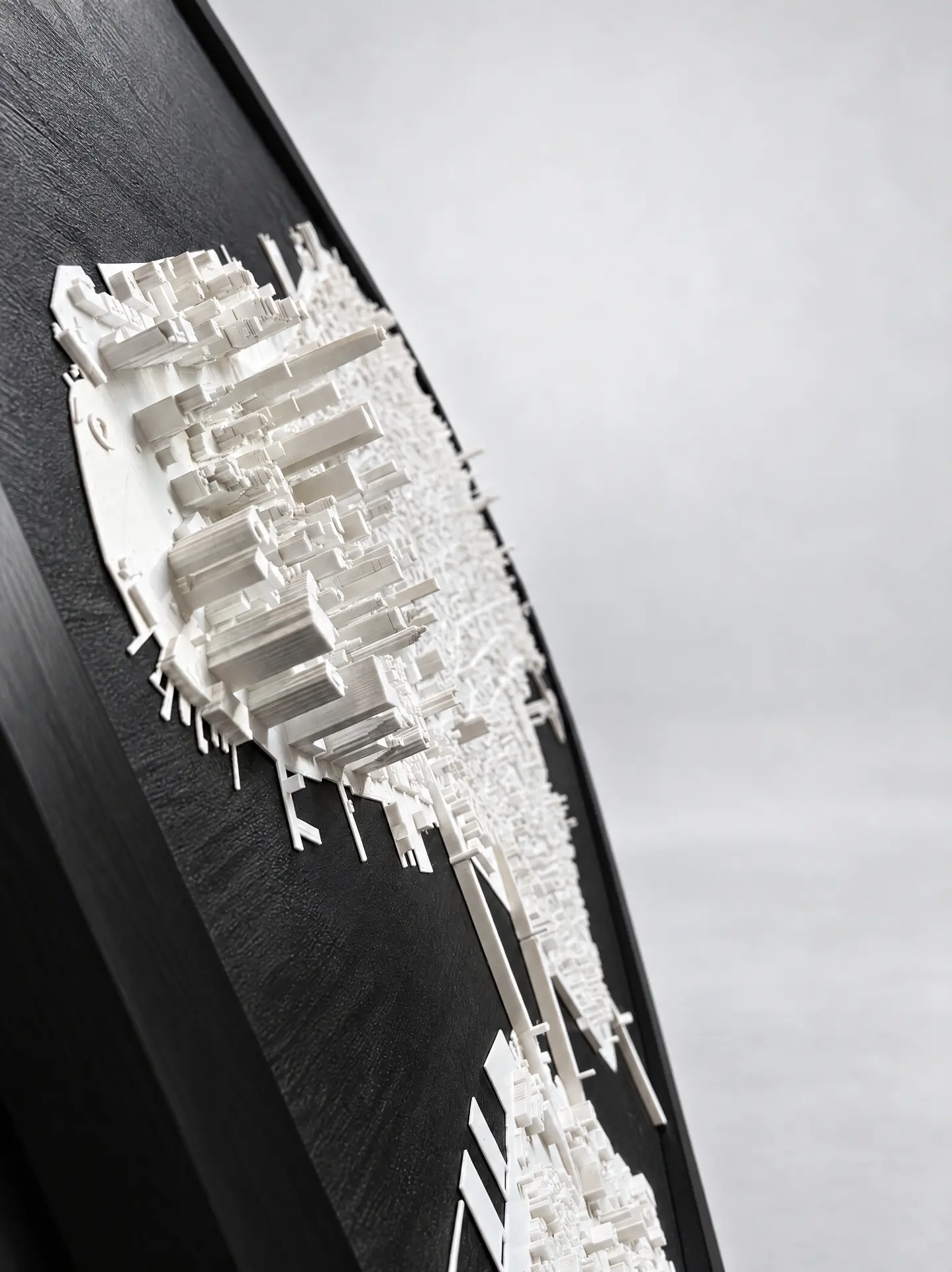 Angled close-up of the printed relief's skyscraper facades showing the fine printed layer lines