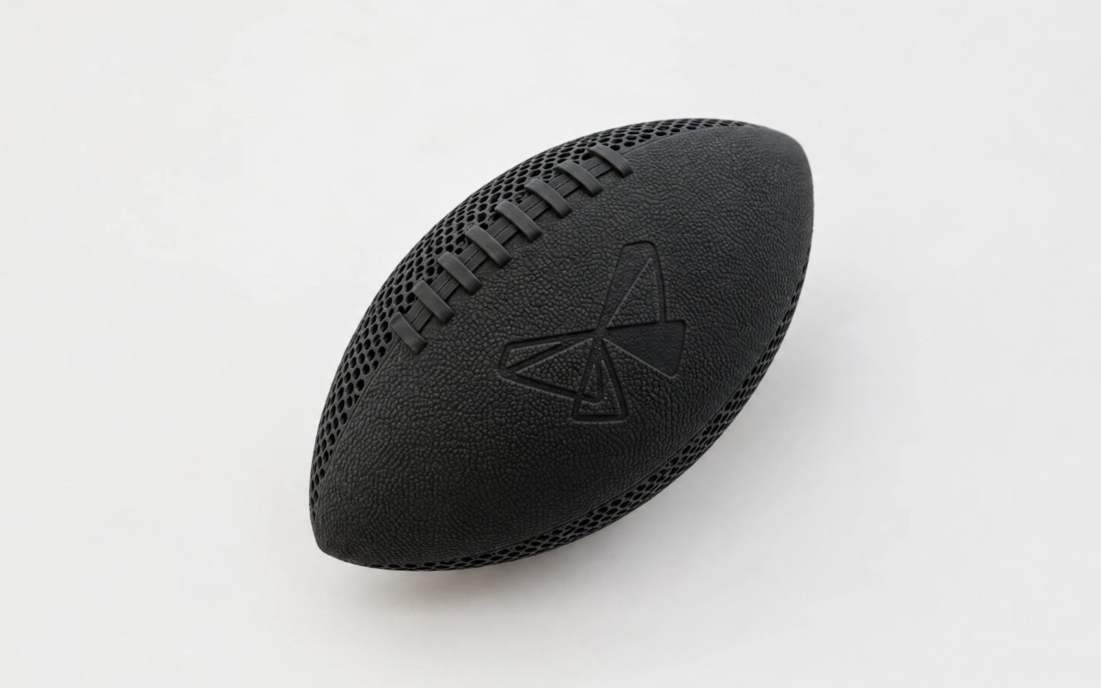 Black airless football printed with an open lightweight nylon lattice