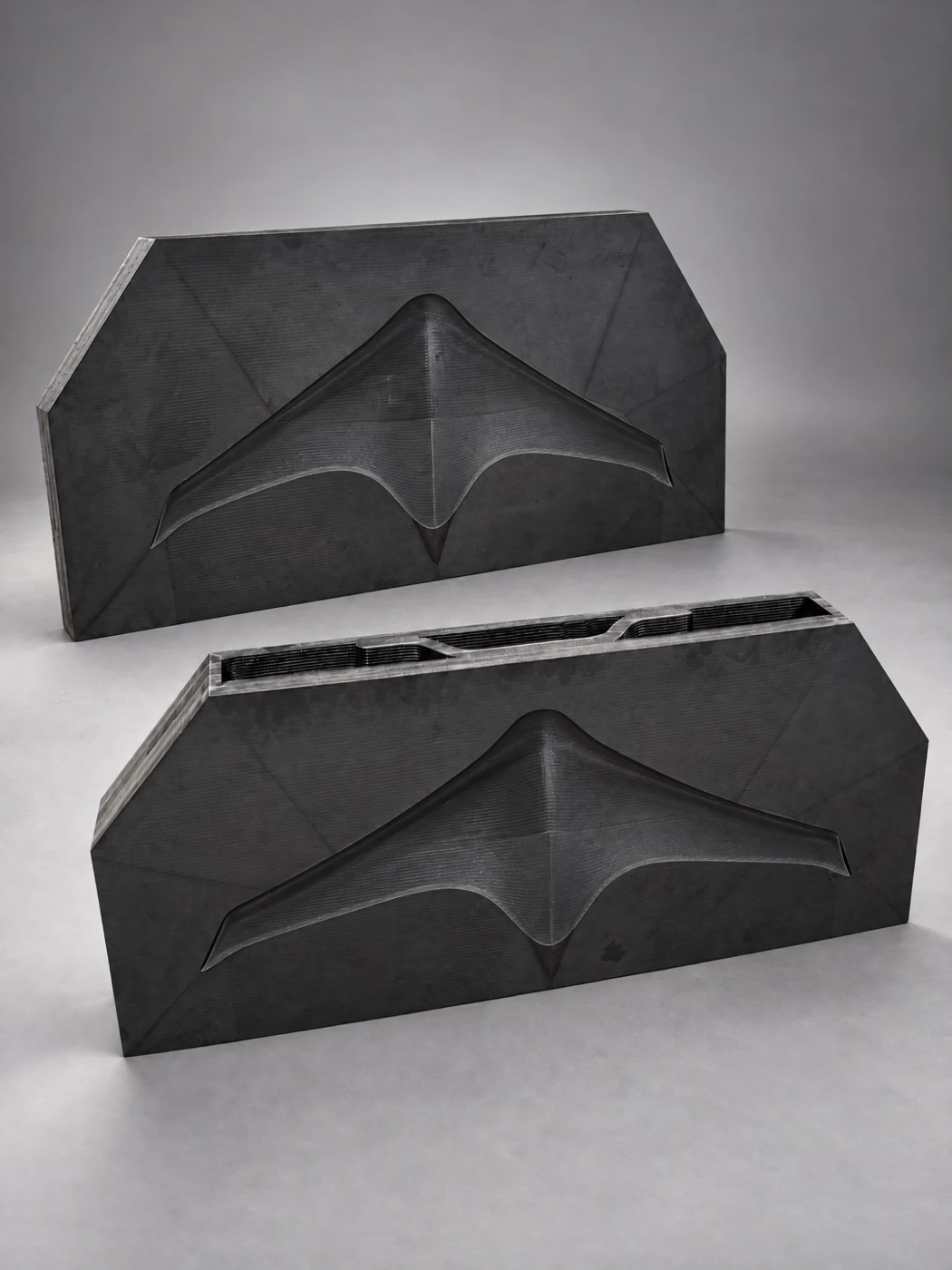 Two large printed mold halves for a flying-wing drone