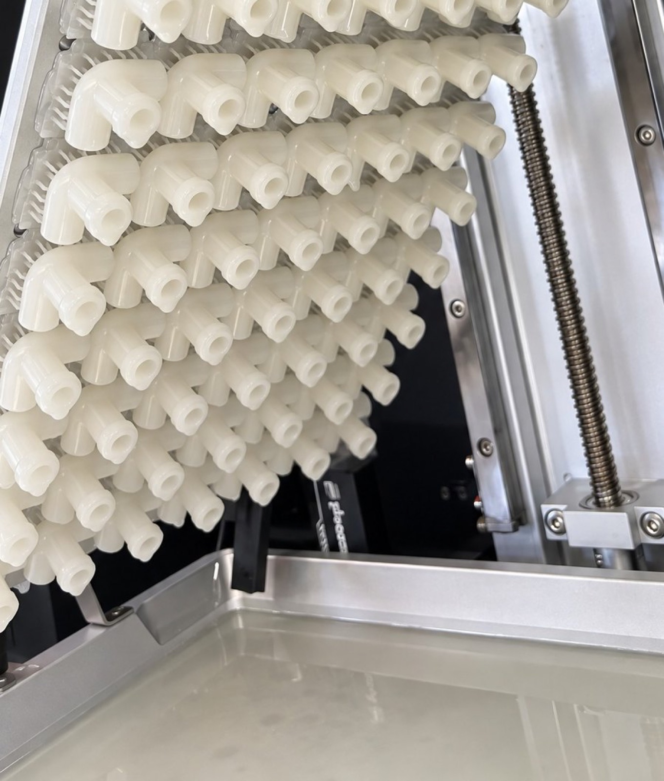 Rows of printed connectors lifted above the resin tank