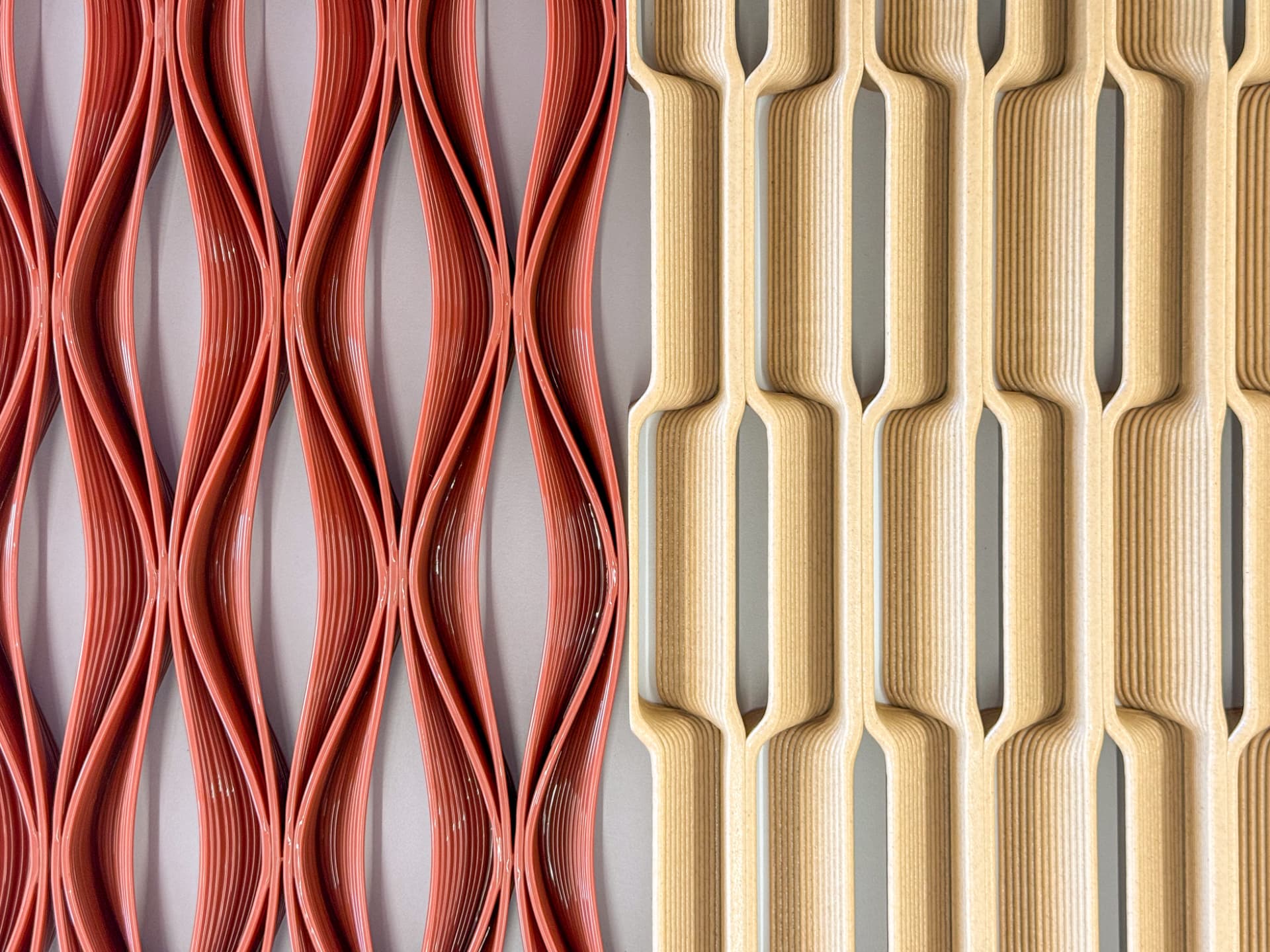 Two 3D-printed lattice panels side by side, a glossy terracotta wave pattern and a matte tan geometric grid, both showing visible extrusion layer lines